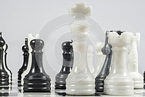 The white king falls under the checkmate of a black pawn. Marble pieces