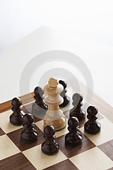 White King Surrounded By Black Pawns