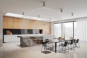 White kitchen corner with island and dining table