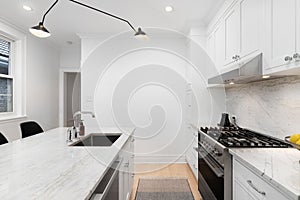 A white kitchen detail with stainless steel appliances.