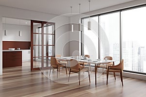 White kitchen interior with eating and cooking room, panoramic window