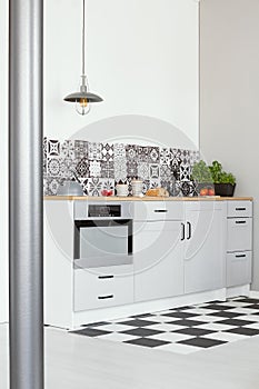 White kitchen interior with elegant wooden cupboards and kitchen accessories