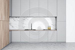 White kitchen interior with gray countertops