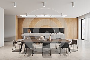 White kitchen interior with island and dining table