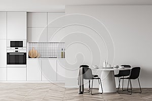 White kitchen interior with round dining table and mock up