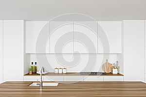 White kitchen interior with wooden island