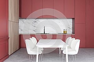 White kitchen with red counters and table