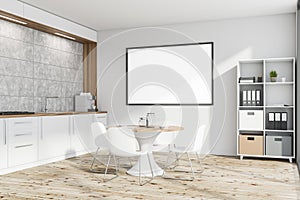 White kitchen with table, poster and bookcase