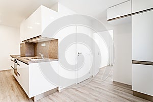white kitchen unit in a new empty modern apartment