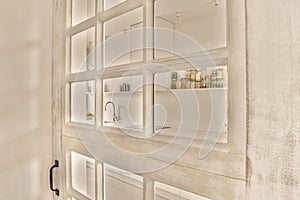 a white kitchen with white cabinets and glass shelves