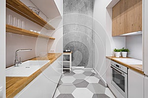 White kitchen with wooden countertop