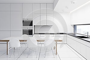 White kitchenette with a table