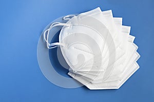 White KN95 or N95 mask for protection against coronavirus on brown background. Surgical protective mask.