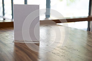 White label in cafe. display stand for acrylic tent card in coffee shop. mockup menu frame on table in bar restaurant.