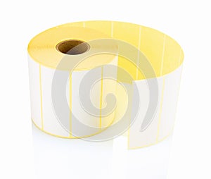 White label roll isolated on white background with shadow reflection. White reel of labels for printer.
