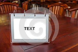 White label for text or image is placed on the table.