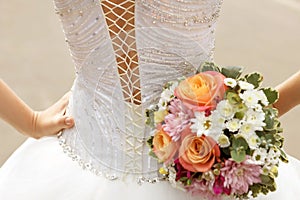 White lace corset wedding dress of the bride and the bridal bouquet