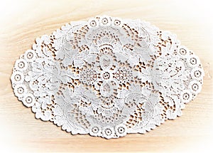 White lace doily Plauener spitze (Plauen lace) on wooden background