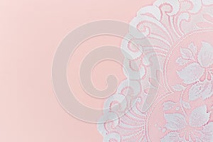 White Lace Fabric on Soft Pink Background. Copy space