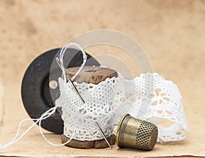 White lace ribbon, wound on a wooden bobbin with