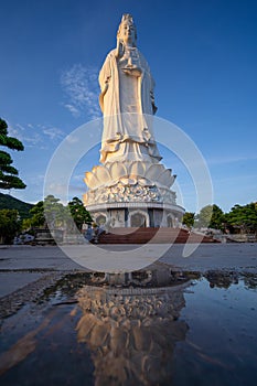 White Lady Buddha at Linh Ung Pagoda in Danang (Da Nang), Vietnam. Majestic white Buddha statue on blue sky background.