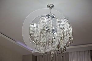 Huge crystal chandelier in the hall . White lamp in the large meeting room photo