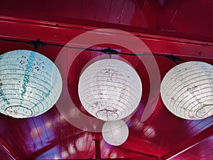 White lamps hung on the red ceiling.