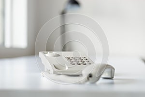White landline telephone with handset off line photo