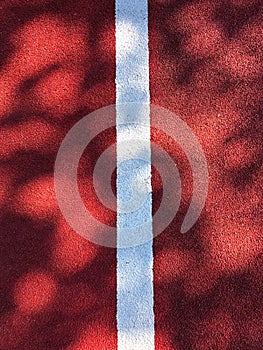 White lane dividing line on red background