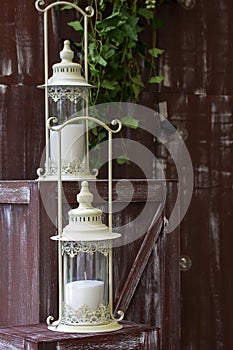 White lantern on browm wooden background or fence.