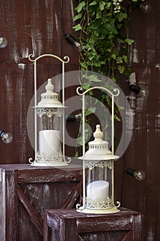 White lantern on browm wooden background or fence.