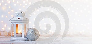 White lantern with candle and silver ball - Christmas decoration. Banner.