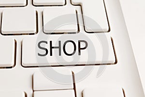 white laptop computer keyboard with the words shop on the key