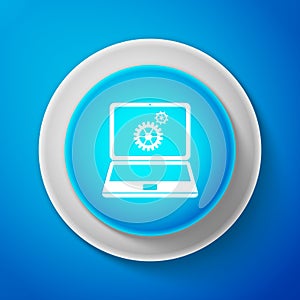 White Laptop and gears icon isolated on blue background. Laptop service concept. Adjusting app, setting options