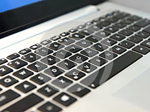 White laptop keyboard with black keys closeup