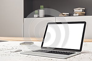 White laptop screen on blurry light designer desktop