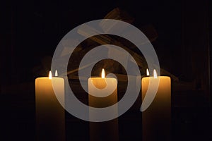 White large candles standing on the fireplace.