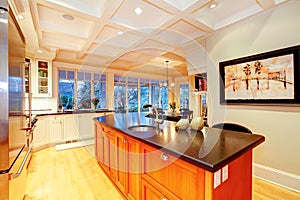 White large luxury kitchen with huge wood island.