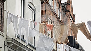 White laundry attached to a laundry line above the street