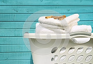 White laundry basket with towels and pins