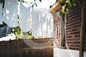 White laundry hangs to dry at a vintage workers` cottage in a small dutch village