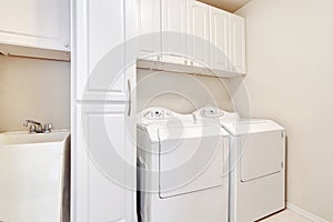 White laundry room with washer and dryer.