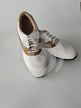 White leather boots with brown inserts for golf
