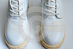 White leather boots with yellow stains