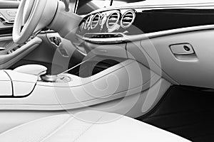 White leather interior of the luxury modern car. Leather comfortable white seats and multimedia. Steering wheel and dashboard. aut