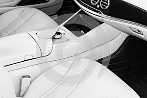 White leather interior of the luxury modern car. Leather comfortable white seats and multimedia. Steering wheel and dashboard. Aut