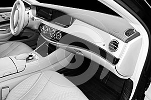 White leather interior of the luxury modern car. Leather comfortable white seats and multimedia. Steering wheel and dashboard. Aut