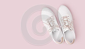 White leather sneakers with laces isolated on pink background