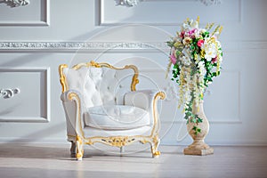 White leather vintage style chair in classical interior room with big window and spring flowers