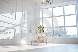 White leather vintage style chair in classical interior room with big window and spring flowers